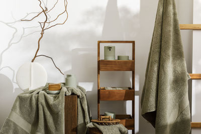 Rear view of woman standing by curtains at home