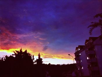 Low angle view of built structure against sky at sunset