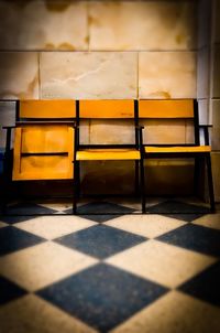 Empty tiled floor against wall at sunset