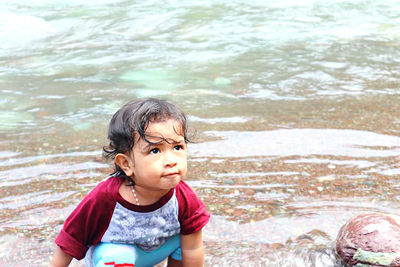 Portrait of cute boy in water