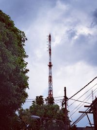 Low angle view of communications tower against sky