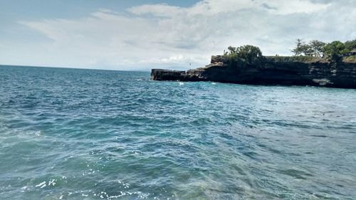 Scenic view of sea against cloudy sky