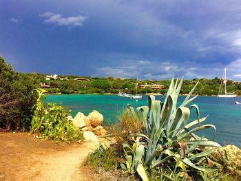 View of calm blue sea against cloudy sky