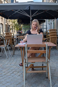 Young woman sitting on chairs