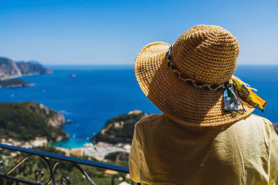 Rear view of man wearing hat against sea