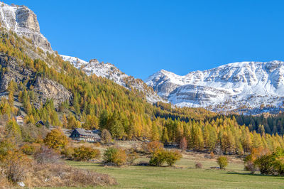 Scenic view of mountains against clear blue sky