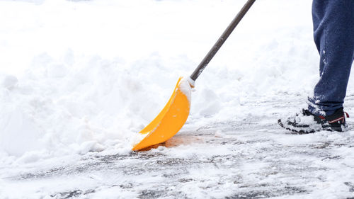 Low section of man skiing on snow