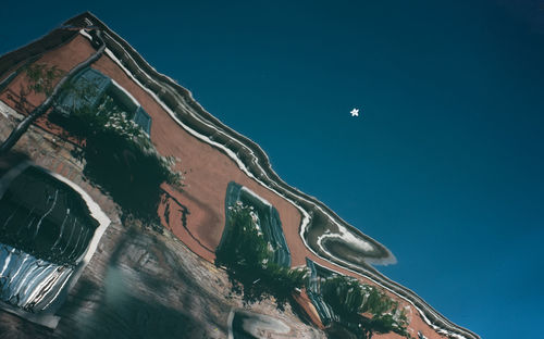 High angle view of building reflecting on calm lake