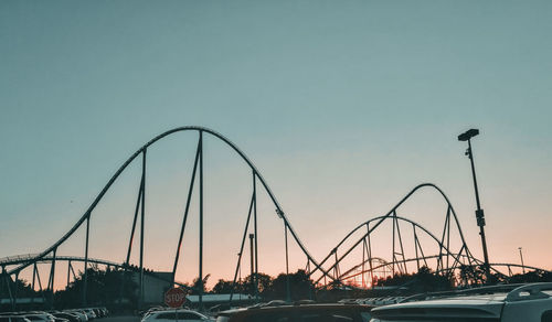 Cars on road against sky during sunset
