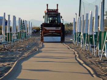 Wooden pier on beach against clear sky