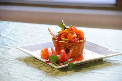 Close-up of serving food in plate on table