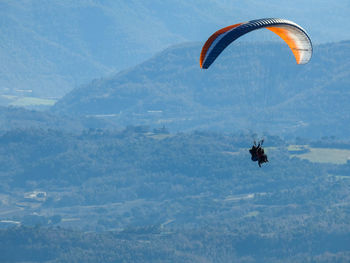 Person paragliding against the sky