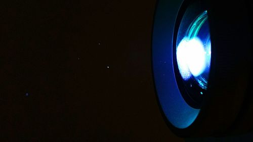 Close-up of illuminated lamp against sky