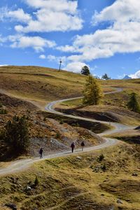 People on landscape against sky