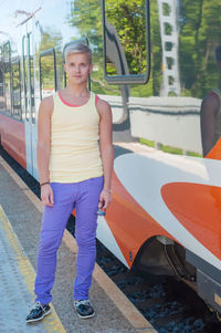 Portrait of young woman standing on bus