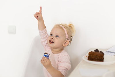 High angle view of girl playing with toys on white background