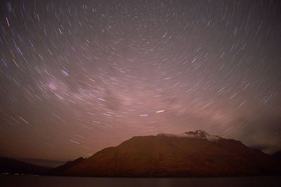 Scenic view of mountains against sky at night