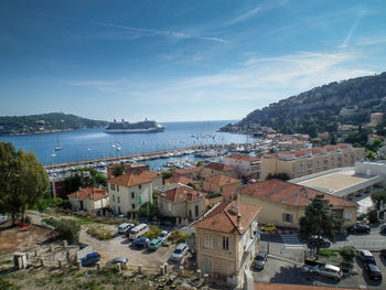 High angle view of city by sea against sky