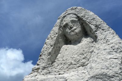 Low angle view of statue against rock formation