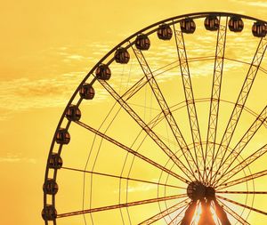 Low angle view of ferris wheel against sky