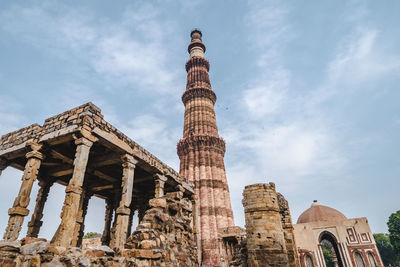 Low angle view of old temple against cloudy sky