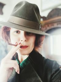 Portrait of beautiful woman holding hat