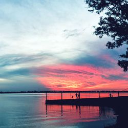 Scenic view of lake against orange sky