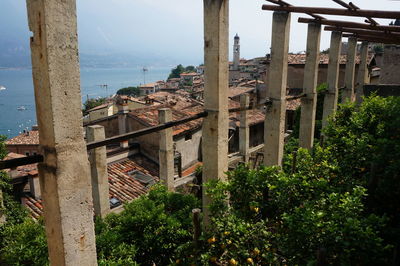 Buildings by sea against clear sky