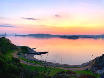 Scenic view of lake against sky during sunset