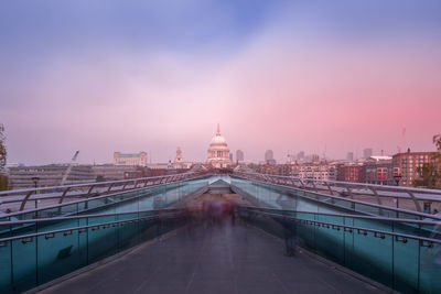 View of bridge and buildings against sky at sunset
