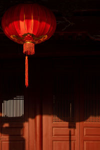 Red lantern hang in roof shadow