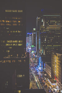 Illuminated modern buildings in city at night