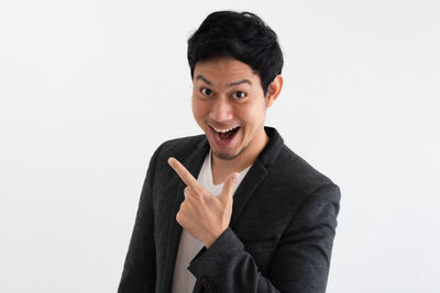 Portrait of smiling man standing against white background