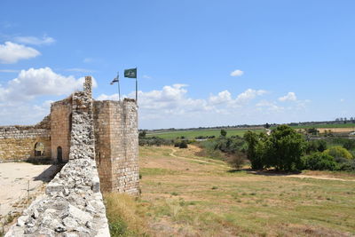 Historic fort by landscape against sky