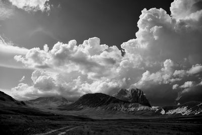 Scenic view of sea and mountains against sky