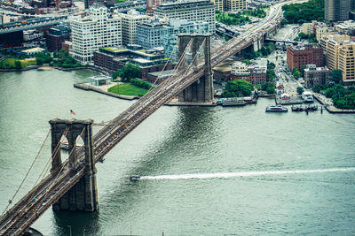 High angle view of bridge over river by buildings in city