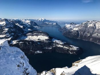 High angle view of snowcapped mountains against sky