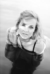 High angle portrait of beautiful woman standing in sea