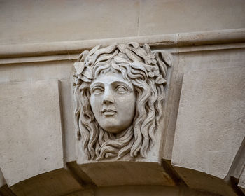 Low angle view of statue against wall