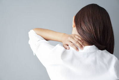 Rear view of woman against white background