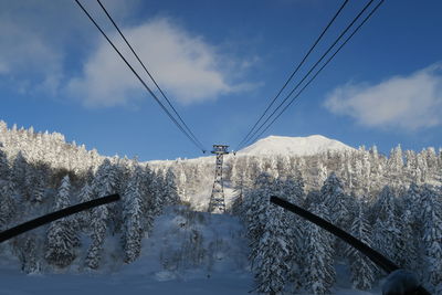 Overhead cable car against sky during winter