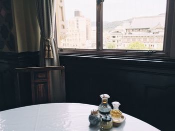 Glass on table by window at home