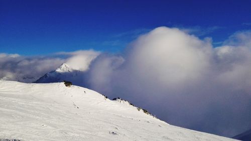Low angle view of snowcapped mountain against sky
