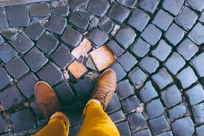 Low section of man standing on street