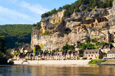 Panoramic view of buildings and mountain against sky