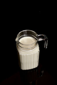 Close-up of coffee in glass against black background