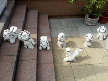 High angle view of statues on tiled floor