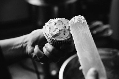 Close-up of hand holding ice cream