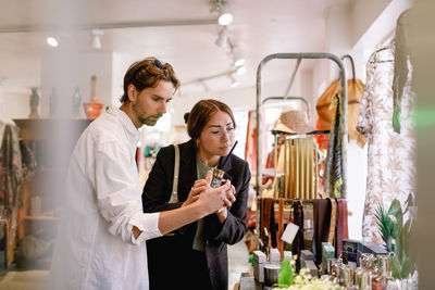 Young couple smelling perfume at fashion store