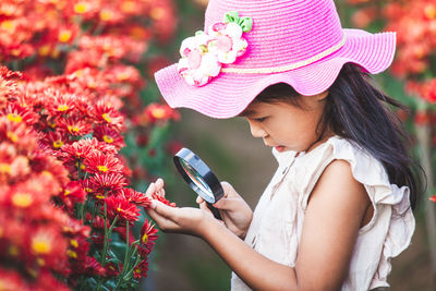 Low section of girl holding mobile phone